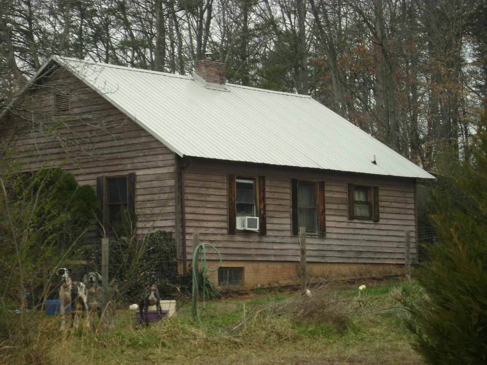White metal roof on an old wood sided farmhouse, from a Metal Roof Installation job in Rembert